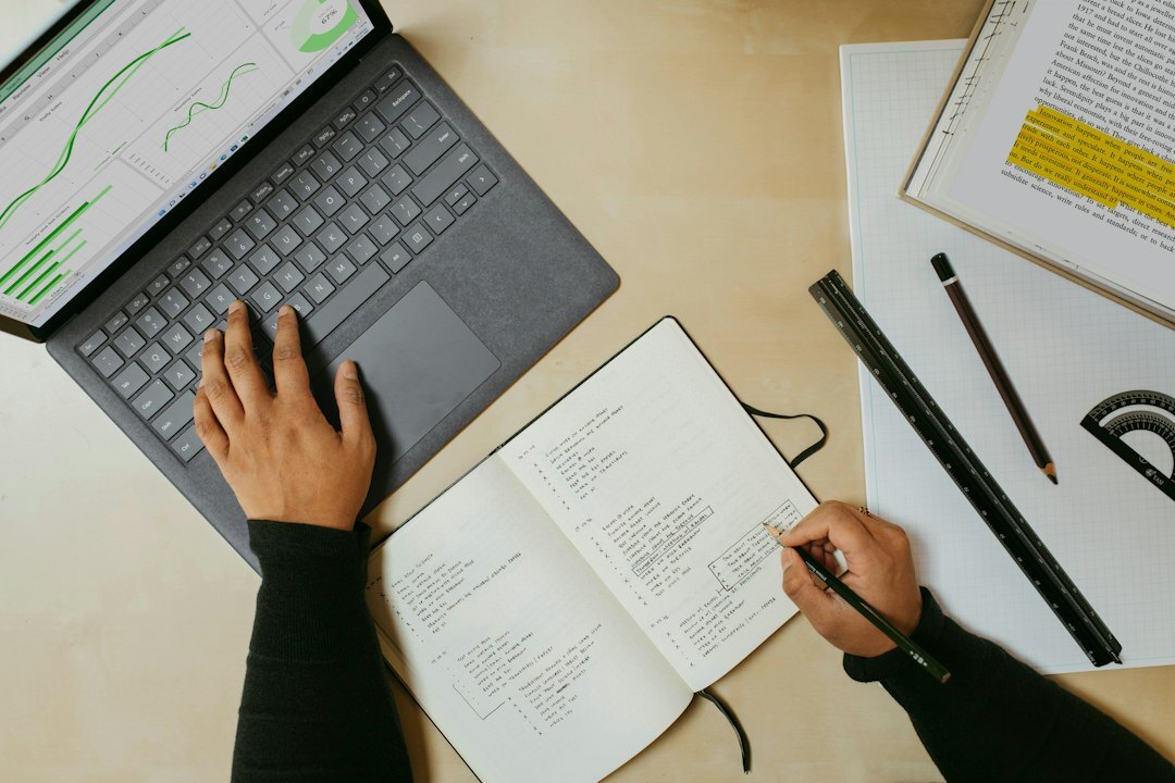 person writing notes in notebook